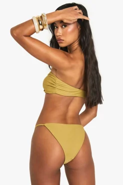 Bas de bikini tanga avec garniture en pierre résineuse et détail d'anneau doré