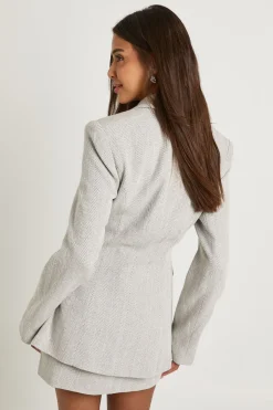 Blazer cintré à nouer en motif chevron