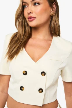 Blazer court sans col à boutons contrastés