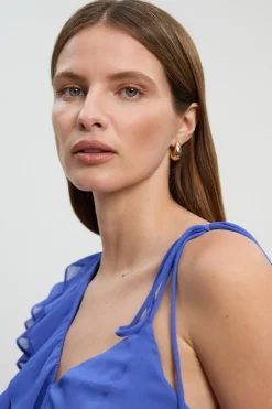 Blouse asymétrique en mousseline avec détails à volants