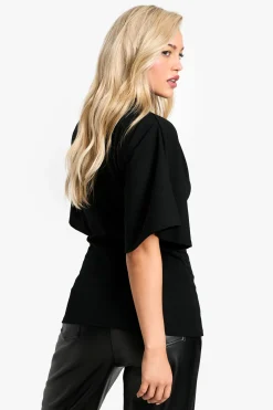 Blouse en crêpe jersey à col haut et manches évasées