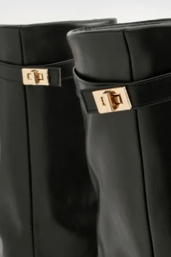 Bottes hautes jusqu'au genou avec détail de boucle et talon bloc repliable.