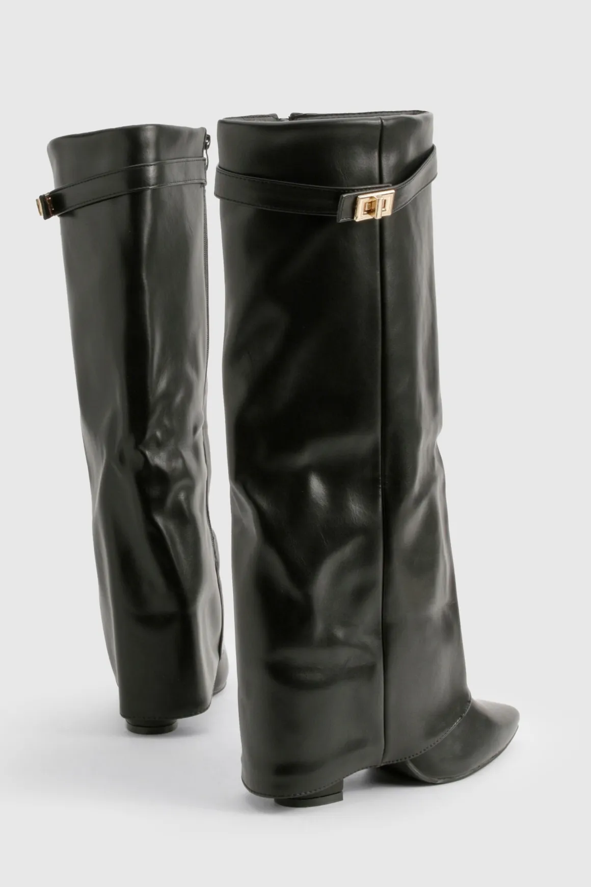 Bottes hautes jusqu'au genou avec détail de boucle et talon bloc repliable.