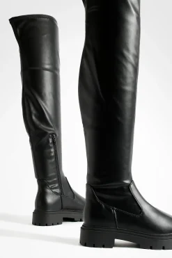 Bottes plates massives au-dessus du genou
