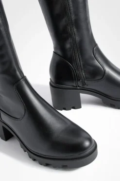 Bottes à talon bloc qui montent au-dessus du genou