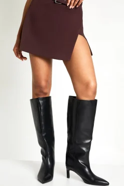 Bottes à talons hauts montantes jusqu'au genou, coupe large et bout pointu