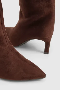 Bottes à talons hauts montantes jusqu'au genou, bout pointu et coupe large