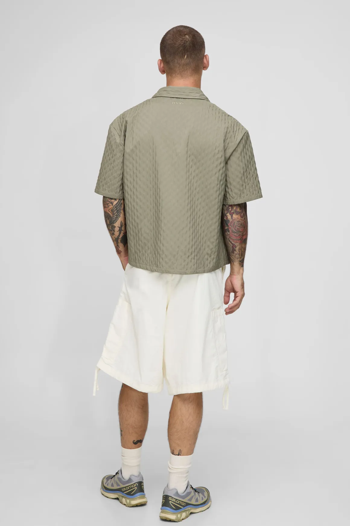 Chemise à manches courtes surdimensionnée avec plis décoratifs et ourlet incurvé