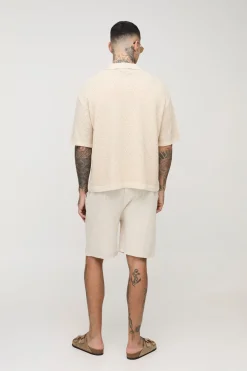 Chemise tricotée longue à manches courtes, coupe boxy, à points de couture ouverts