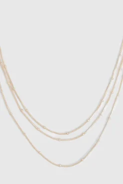 Collier superposé délicat à boules et chaînes