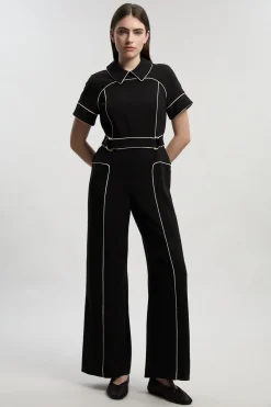 Combinaison Ajustée à Détails Contrastés et Pattes Boutonnées en Tissu Stretch Compact