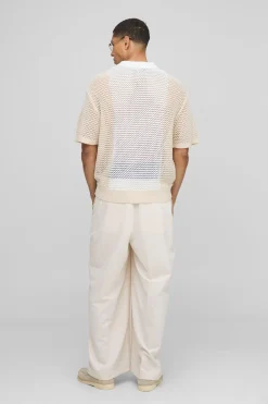 Coupe boxy, blocs de couleur, point ouvert, col zippé, polo tricoté