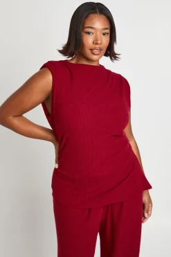 Haut avec épaulettes, détails plissés, ourlet asymétrique et pantalon à jambes larges