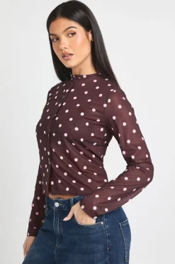 Haut à bouton traversant en maille imprimée à pois