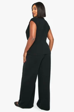 Haut drapé à manches cap orné d'une bordure dorée et pantalon à jambes larges