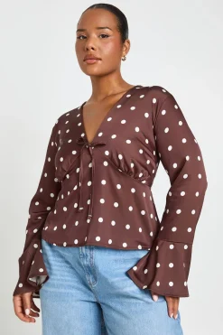 Haut Grande Taille Péplum Satiné À Pois Avec Nœud Devant