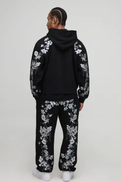 Hoodie à capuche oversize et cubique, avec surpiqûres apparentes, broderie florale et fermeture éclair intégrale.