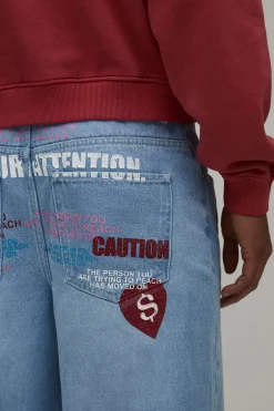 boohooMAN Jean Ample Teinté À Imprimé Graphique Attention Intégral<Homme Denim|Denim