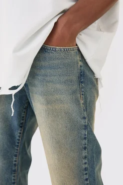 Jean en denim teinté à effet flare décontracté avec déchirure rigide au niveau du genou
