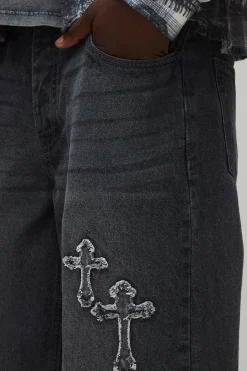 Jeans coupe baggy lavés à appliqué croisé