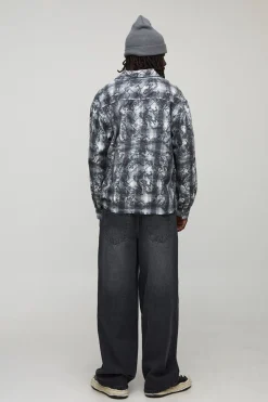 Jeans coupe baggy lavés à appliqué croisé