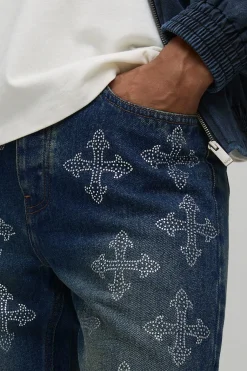 Jeans en denim à coupe superposée et évasée, ornés de strass disposés en croix