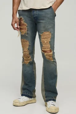 Jean slim rigide à jambes évasées, détails déchirés, lavé