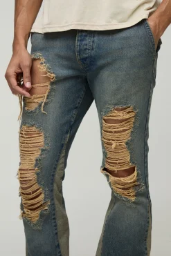 Jean slim rigide à jambes évasées, détails déchirés, lavé