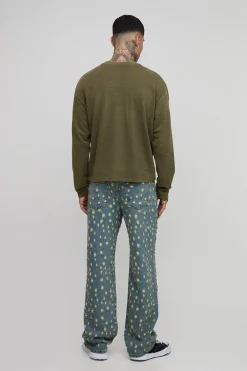 Jeans longs teintés, déchirés de façon extrême, coupe décontractée