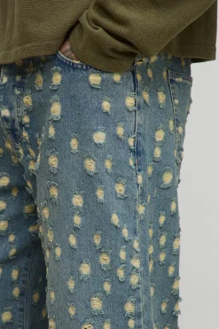 Jeans longs teintés, déchirés de façon extrême, coupe décontractée