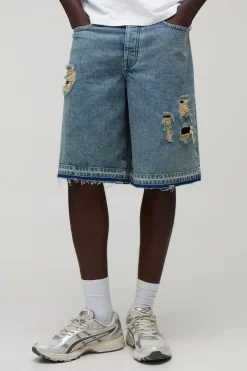 Jorts bleu déchirés à coupe régulière avec ourlet tombé