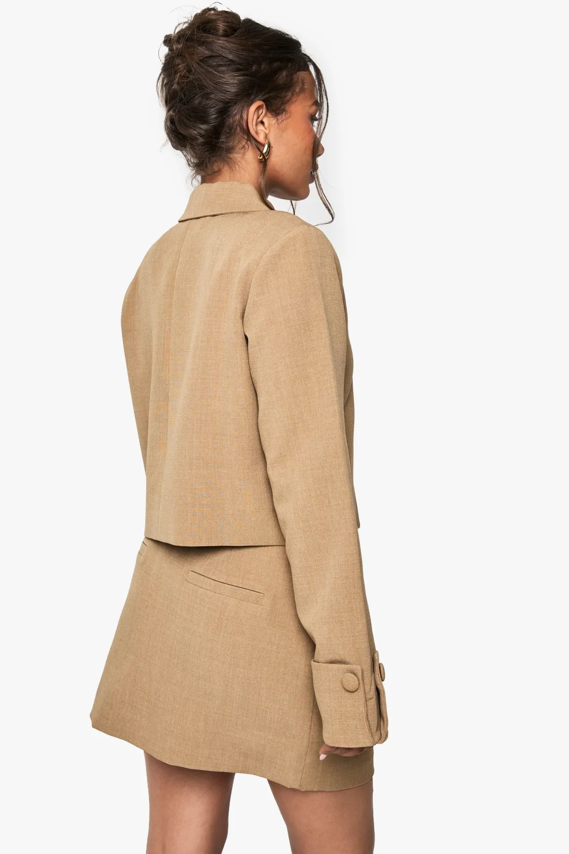 Jupe mini tissée ajustée avec poche avant