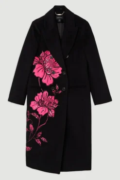 Manteau mi-long sur mesure à double boutonnage en mélange de laine avec appliques en satin embellies