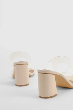 Mules à talon bloc, double bride transparente, coupe large