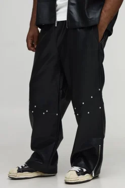 Pantalon à l'aspect cuir clouté, ourlet zippé, coupe décontractée