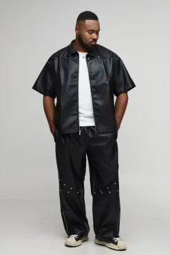 Pantalon à l'aspect cuir clouté, ourlet zippé, coupe décontractée