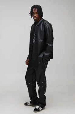 Pantalon long clouté à l'aspect cuir, ourlet zippé et coupe décontractée