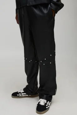 Pantalon long clouté à l'aspect cuir, ourlet zippé et coupe décontractée