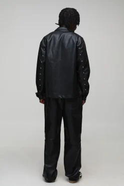 Pantalon long clouté à l'aspect cuir, ourlet zippé et coupe décontractée