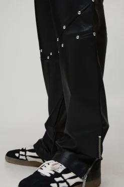 Pantalon long clouté à l'aspect cuir, ourlet zippé et coupe décontractée