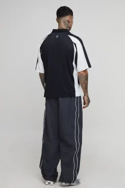 Pantalon parachute brodé aux grandes rayures