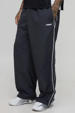 Pantalon parachute brodé aux grandes rayures