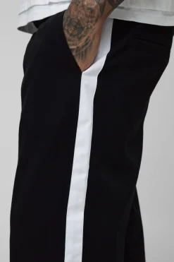 Pantalon taille haute avec élastique, coupe décontractée et panneau latéral.