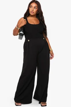 Pantalon tailleur à jambe large, taille élastiquée et garniture dorée