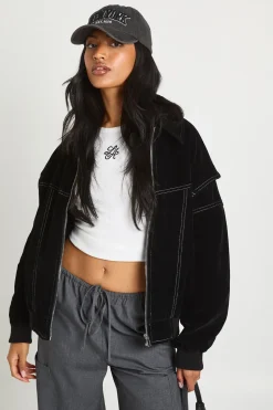 Petite veste bomber en suédé synthétique à surpiqûres contrastées