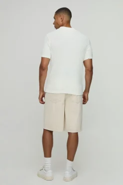 Polo tricoté à motif gaufre, à col boutonné, coupe régulière