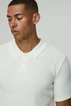 Polo tricoté à motif gaufre, à col boutonné, coupe régulière