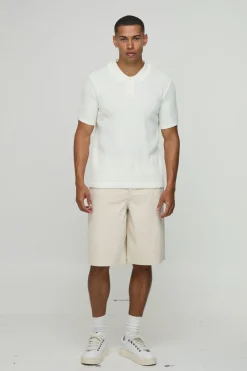 Polo tricoté à motif gaufre, à col boutonné, coupe régulière