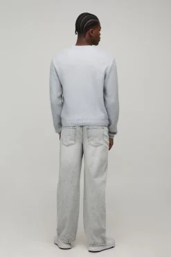 Pull tricoté à coupe boxy, finition brossée et estampillé