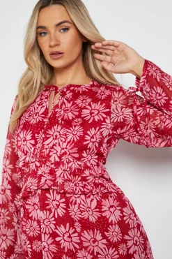 Robe Midi Trapèze Imprimée à Col Noué et Détails Volantés Motif Marguerites Roses